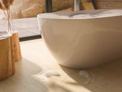 Freistehende Badewanne in einem modernen Badezimmer mit Sedrun Oak Laminatboden und minimalistischem Design - artureon Laminat